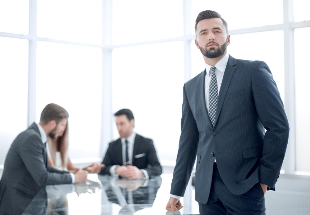 Business professional wearing a perfectly fitted suit during a meeting.